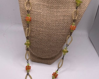 COLLEEN TOLAND signed vintage necklace with red flowers and hand crafted designs with colored beads.