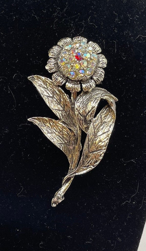 Rhinestones flower silver tone brooch.