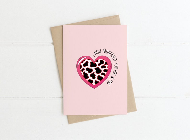 May include: A pink card with a cow print heart and the text "I now pronounce you Mr. & Mrs."