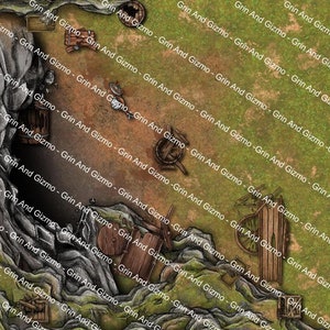 May include: A top-down view of a miniature tabletop game terrain featuring a cave opening with a rocky overhang and a grassy area with scattered wooden barrels and wheels. The terrain is designed for use in fantasy role-playing games.