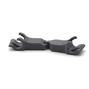 May include: A gray plastic clip with two prongs on each end. The clip is designed to hold two objects together.