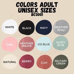 May include: Color chart showing available colors for adult unisex t-shirts. Colors include white, black, navy, heather grey, pink, heather mauve, ice blue, dusty blue, natural, berry, clay, and military green.