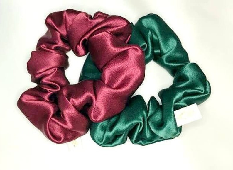 May include: Two satin scrunchies, one burgundy and one dark green.