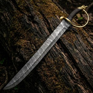 May include: A Damascus steel sword with a curved blade and a brass hilt. The handle is wrapped in black leather. The sword is resting on a moss-covered log, showcasing its intricate pattern and craftsmanship.