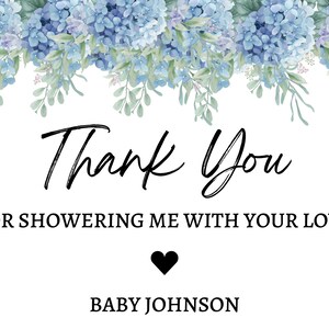 May include: Thank You for showering me with your love. Baby Johnson. A white card with black text and a black heart.