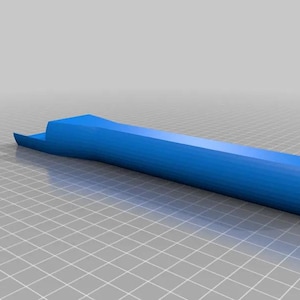 Op de afbeelding: Een blauwe kunststof handgreep met een afgerond uiteinde en een platte, licht gebogen bovenkant.