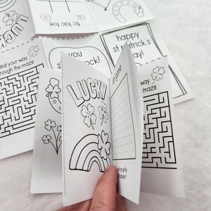 May include: A set of black and white printable colouring pages featuring St. Patrick's Day themes. The pages include a shamrock, a horseshoe, a maze, and the words "Lucky" and "Happy St. Patrick's Day!"