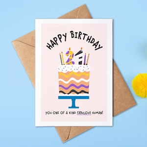 May include: A pink birthday card featuring a colourful cake with candles and the number 21 on top. The text on the card reads "Happy Birthday You one of a kind fabulous human!"