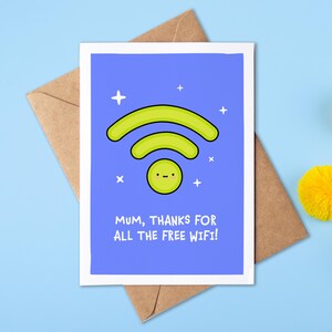 May include: A greeting card with a blue background features a green WiFi symbol and the text "Mum, thanks for all the free WiFi!". The card is on a brown envelope, with yellow pom-poms on a light blue surface.
