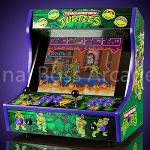May include: A Teenage Mutant Ninja Turtles arcade cabinet with a purple trim and green and black graphics. The cabinet features a screen showing the game in progress, with the four turtles fighting. The cabinet has a joystick and buttons for playing the game.