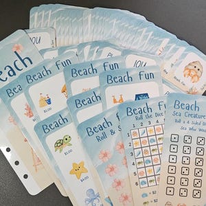 May include: A set of colorful cards for a beach-themed game. The cards feature illustrations of beach-related items, such as seashells, sandcastles, and starfish. The game is called "Beach Fun" and includes a "Sea Creature Race" game board with dice and a grid.