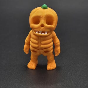 Pumpkin Skeleton Figurine: Spooky Season Decor