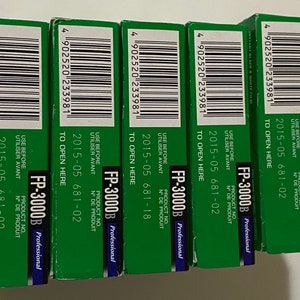 May include: Four packs of Fujifilm FP-3000B professional instant film. Each pack has a green background with white text that reads "FP-3000B Professional", "USE BEFORE", "UTILISER AVANT", "PRODUCT NO.", "N&deg; DE PRODUIT", "2015-05 681-02", and "TO OPEN HERE".