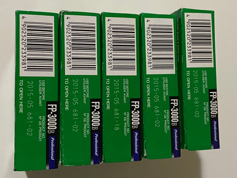 May include: Four packs of Fujifilm FP-3000B professional instant film. Each pack has a green background with white text that reads "FP-3000B Professional", "USE BEFORE", "UTILISER AVANT", "PRODUCT NO.", "N&deg; DE PRODUIT", "2015-05 681-02", and "TO OPEN HERE".