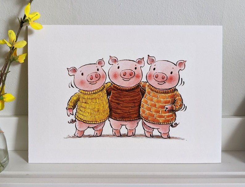 May include: Three pink pigs wearing sweaters, one yellow, one brown, and one orange, are standing side by side and smiling.