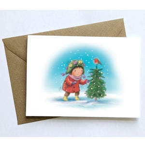 Rouge-gorge arbre de Noël. Carte de Noël A6 illustrée représentant une petite fille décorant un arbre dans la neige. Une seule carte ou des lots de 2, 4 ou 8