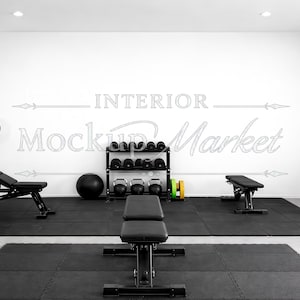 May include: A well-lit home gym featuring various exercise equipment. Includes a weight bench, barbell rack with weights, dumbbells, kettlebells, a medicine ball, and an elliptical machine. The floor is covered with black mats.