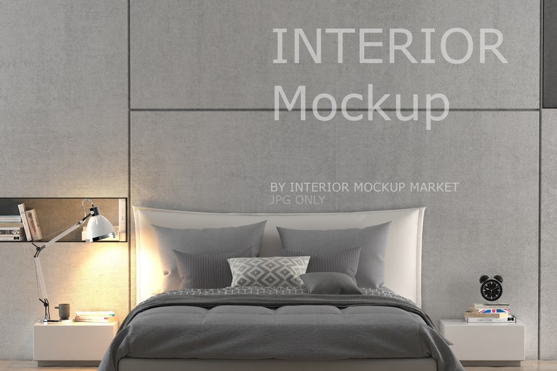 May include: A modern bedroom interior mockup featuring a bed with gray bedding and pillows. A white bedside table holds a lamp, books, and a coffee cup. The wall has the text "INTERIOR Mockup".