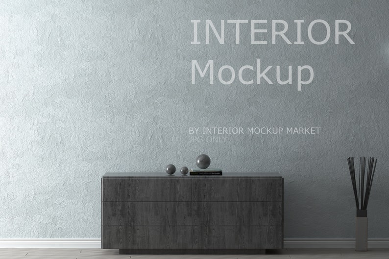 May include: An interior mockup scene featuring a dark gray wooden dresser with six drawers, three decorative spheres, and a book. The text "INTERIOR Mockup" is displayed on the light blue textured wall. A vase with reeds is on the right.
