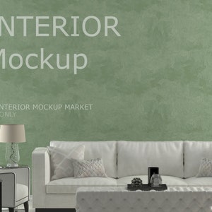 May include: Interior mockup featuring a white sofa, armchair, and ottoman. A decorative lamp and gold elephant statue sit on a side table. The background is a textured green wall. Text on the wall reads "INTERIOR Mockup" and "BY INTERIOR MOCKUP MARKET JPG ONLY."