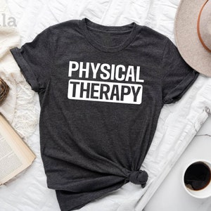 May include: Dark gray heather t-shirt with the text "PHYSICAL THERAPY" in white letters.