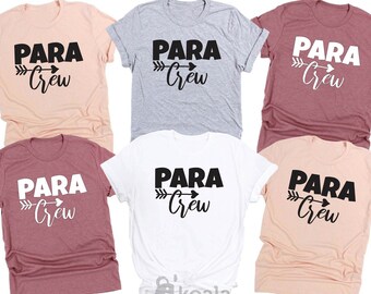 May include: A collection of six t-shirts in various colors, including peach, gray, white, and burgundy. Each shirt features the text "PARA Crew" in a bold, black font with an arrow design. The shirts are short-sleeved.
