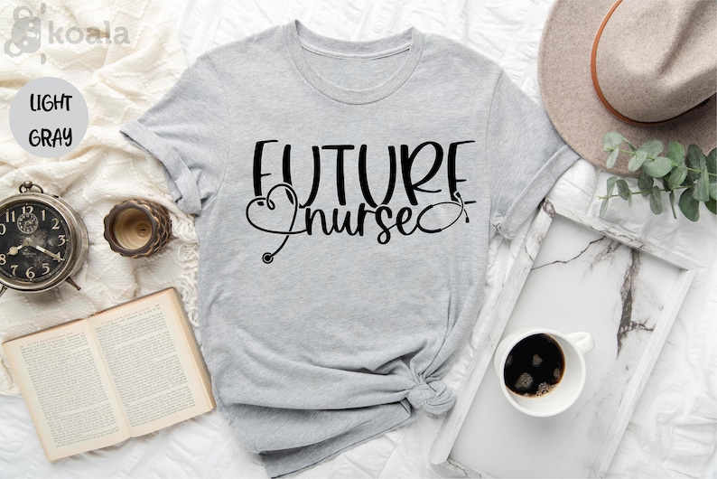 May include: A light gray t-shirt with the text "FUTURE nurse" in black lettering. A stylized stethoscope with a heart is included in the design.