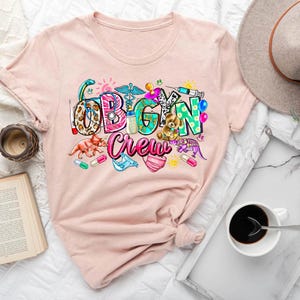 a t - shirt with the word vegan on it next to a cup of