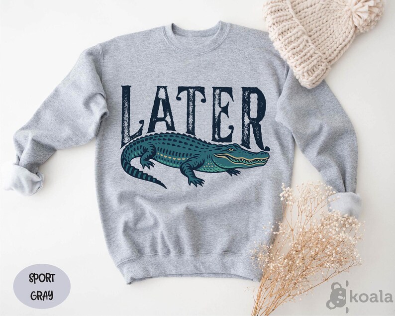 a sweater with the word later on it