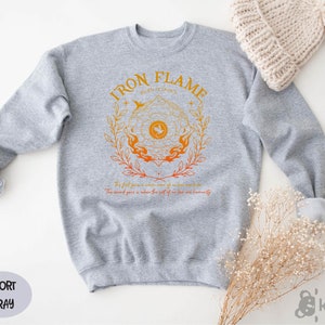 a gray sweatshirt with a gold logo on it
