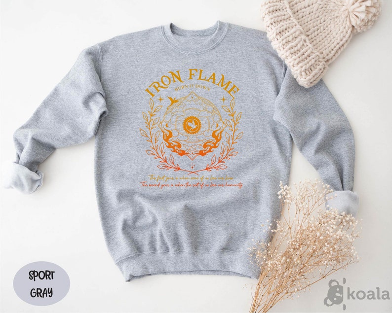 a gray sweatshirt with a gold logo on it