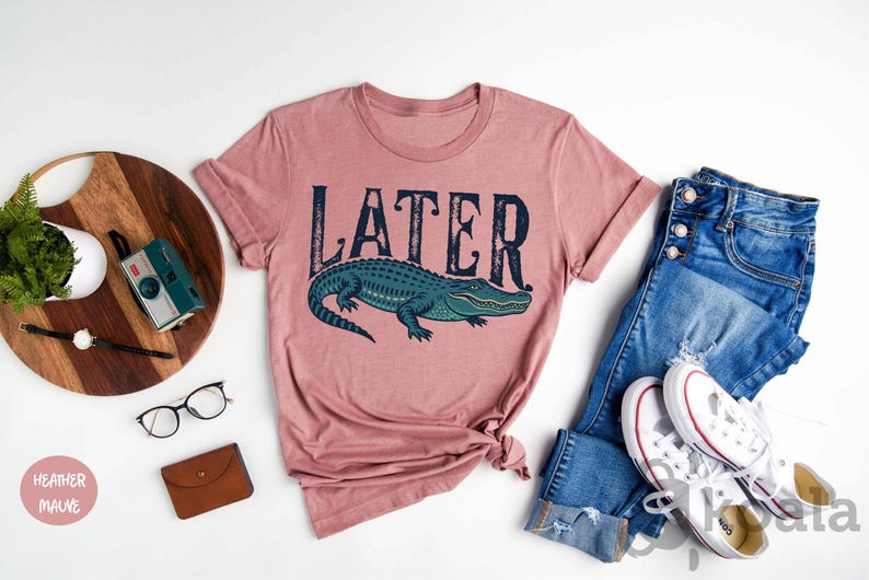 a pink shirt that says later next to a pair of jeans and a pair of