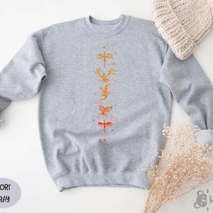 a gray sweater with a yellow and orange design on it