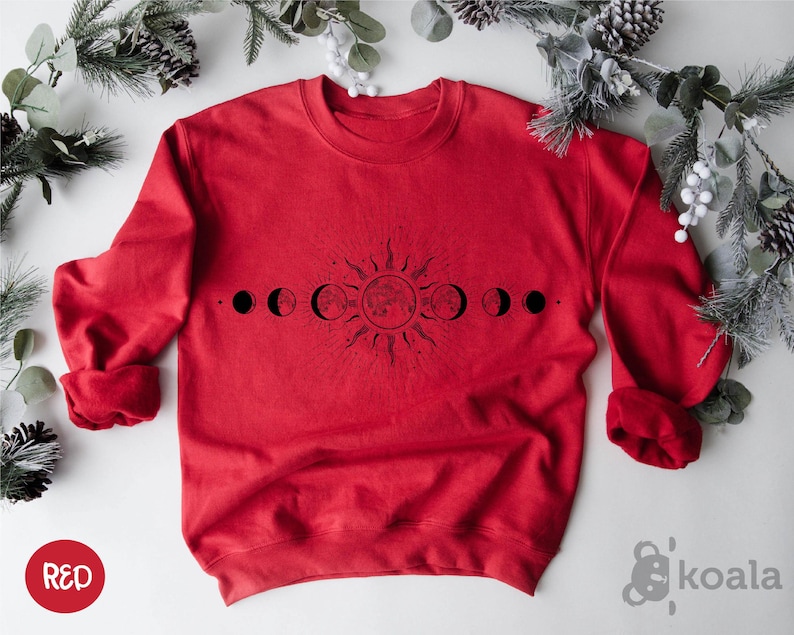 a red sweatshirt with the phases of the moon on it