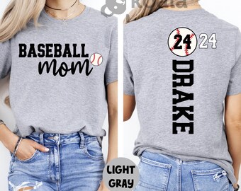 May include: A light gray t-shirt with the text "Baseball Mom" and a baseball graphic on the front. The back of the shirt has the text "Drake" and a baseball with the number "24" on it.