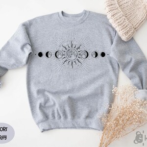 a sweater with the phases of the moon on it