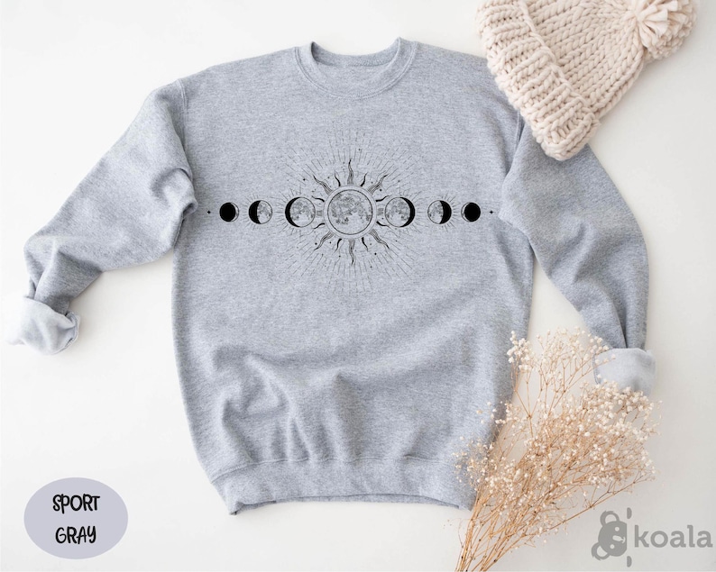 a sweater with the phases of the moon on it