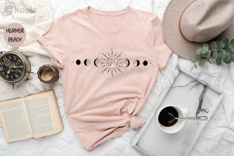 a pink shirt with the phases of the moon on it