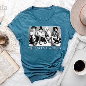 a t - shirt that says you can't sit with us