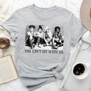a t - shirt that says you can't sit with us