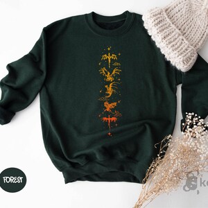 a green sweatshirt with a yellow dragon on it