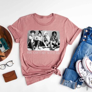 a t - shirt with a picture of three women on it