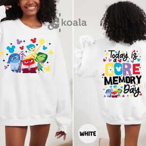 a woman wearing a white sweatshirt with the words today is a core memory day on