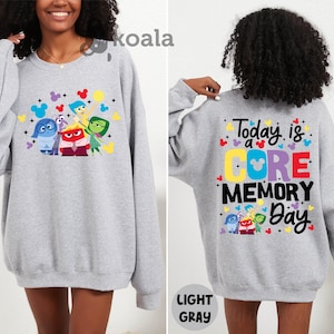 a woman wearing a gray sweatshirt with the words today is a gore memory on it