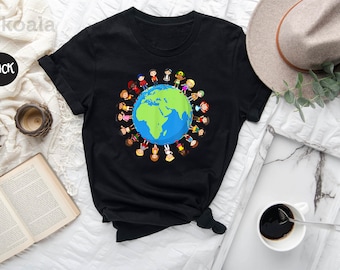 May include: Black t-shirt with a graphic of children holding hands around a globe. The globe is green and blue with continents outlined in blue. The children are diverse and represent different cultures.