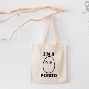 May include: A white tote bag with black text that reads "I'm a Potato" and a cartoon potato with a smiling face.