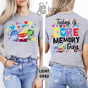 a woman wearing a gray tshirt with the words today is a core memory