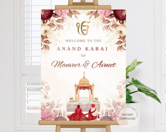 May include: A white wedding sign with gold and red floral accents. The sign says "Welcome to the Anand Karaj of Manveer & Avneet".