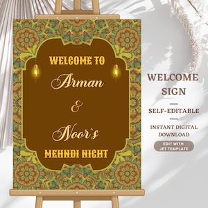 May include: A brown welcome sign on an easel with the text "WELCOME TO Arman & Noor's MEHNDI NIGHT". The sign has a decorative border with a floral design in shades of green, gold, and brown. The words "WELCOME SIGN" are also displayed.