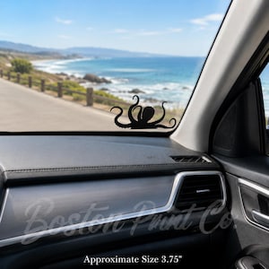 May include: Black octopus decal, approximately 3.75 inches in size, displayed on a car window. The decal is set against a scenic background of a coastal road and ocean. The text "Boston Print Co." is visible.